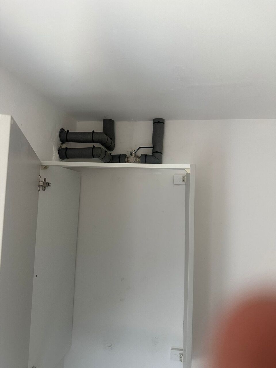 Neat insulated pipework in ceiling cupboard – all existing 10mm plastic pipework retained, Darwen Zero Disruption install
