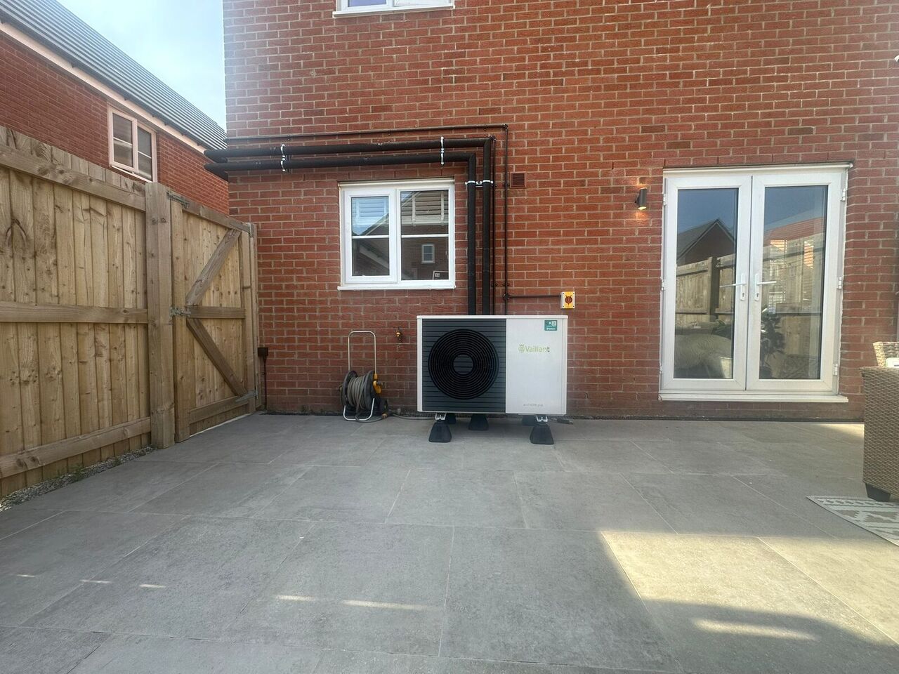 5kW air source heat pump installed on patio outside new-build home in Darwen, Lancashire