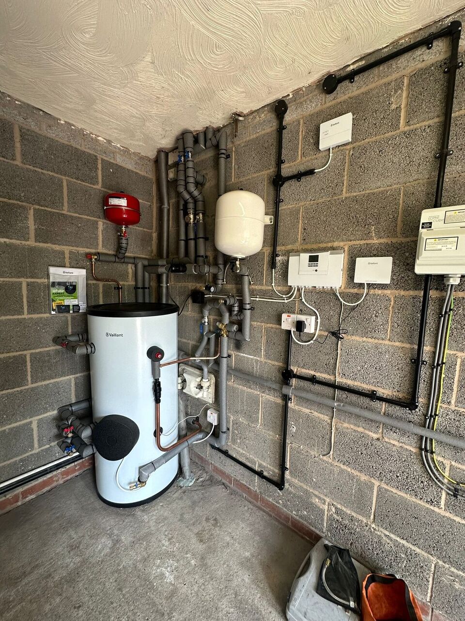 Full plant room overview with hot water cylinder, pipework and controls – 90s detached home, Preston, Lancashire